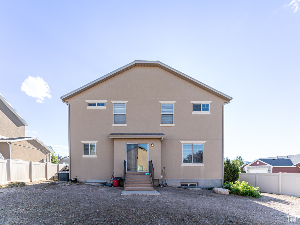 Rear view of property with stucco siding