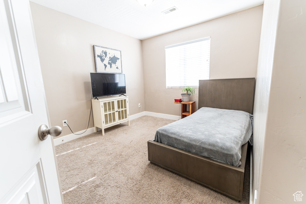 Bedroom with carpet flooring and baseboards