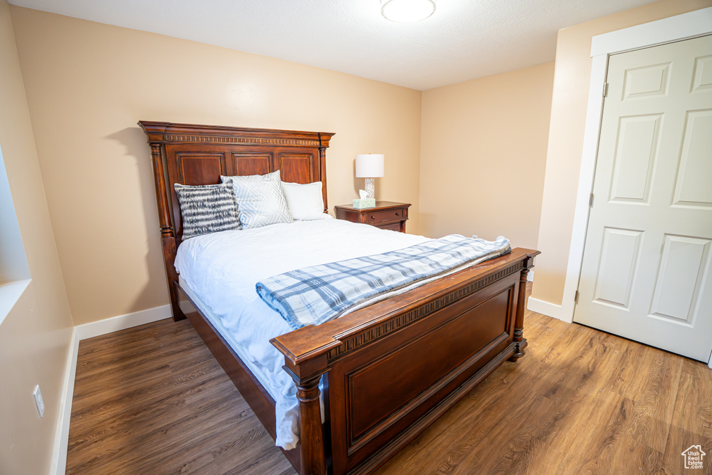 Bedroom featuring wood finished floors and baseboards