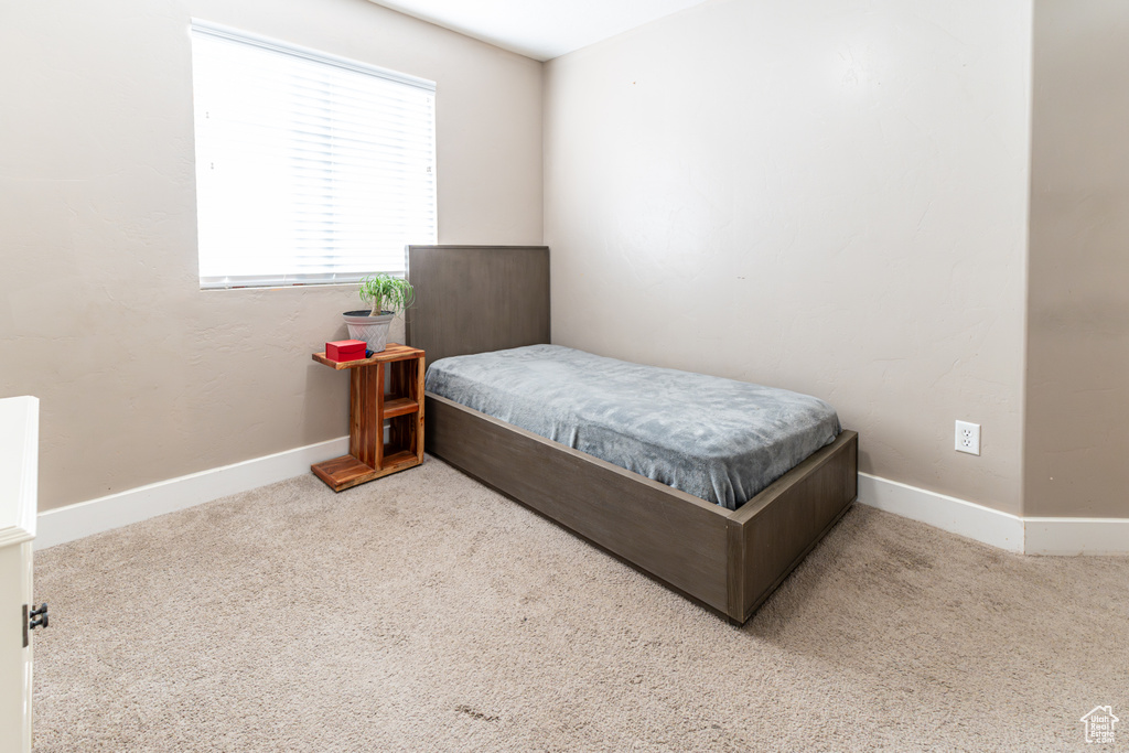 Carpeted bedroom featuring baseboards