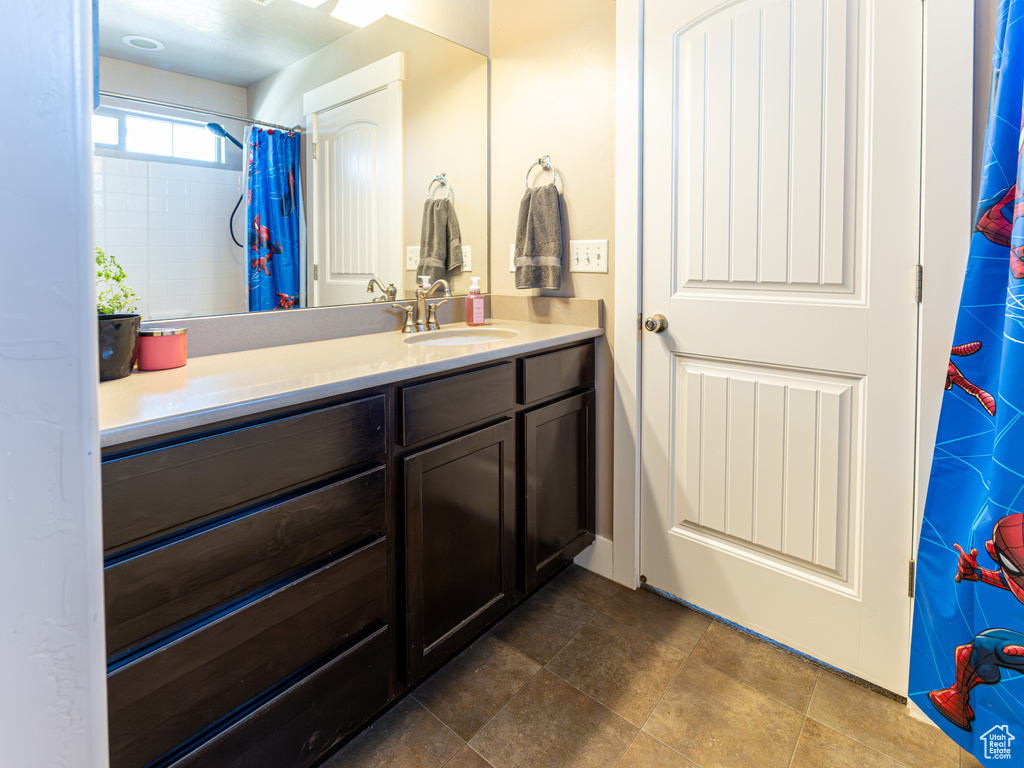 Bathroom featuring vanity and a shower with curtain