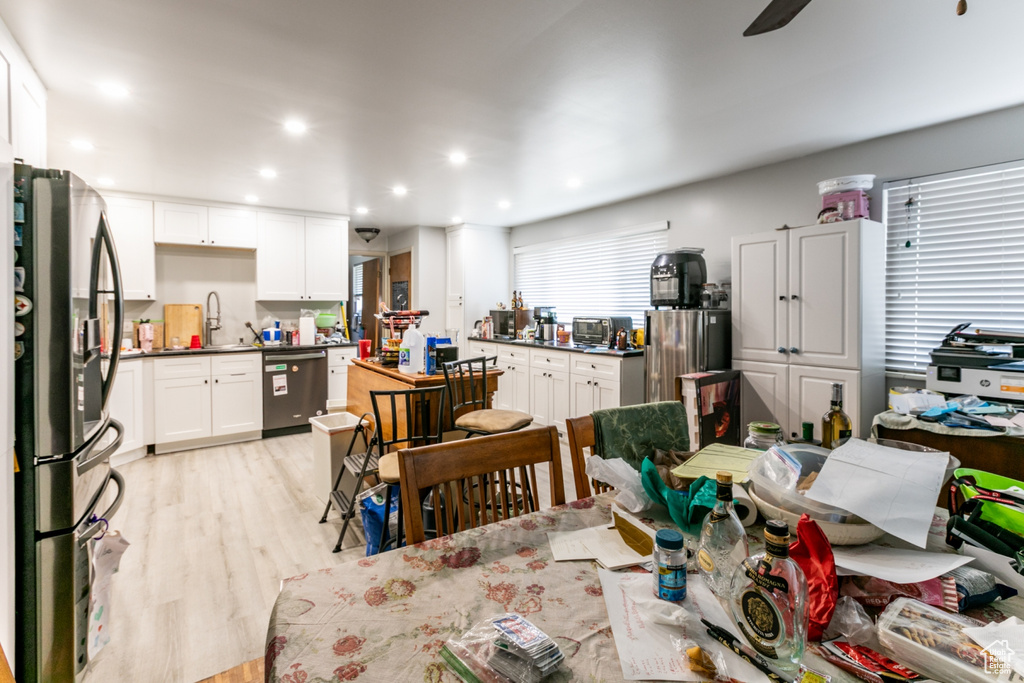 Dining space with light wood-type flooring and recessed lighting