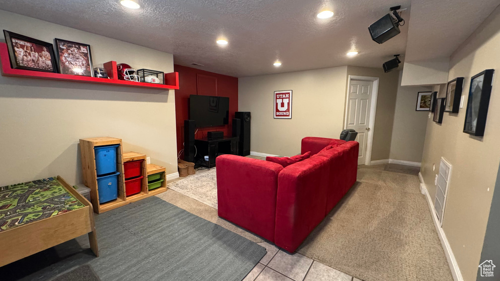 Living room featuring a textured ceiling and recessed lighting