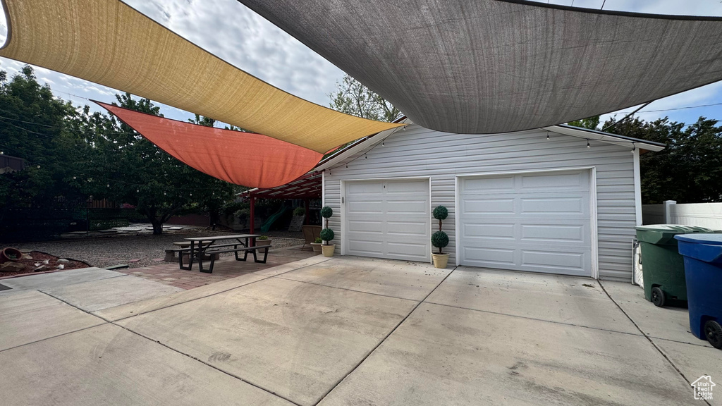 Garage featuring concrete driveway
