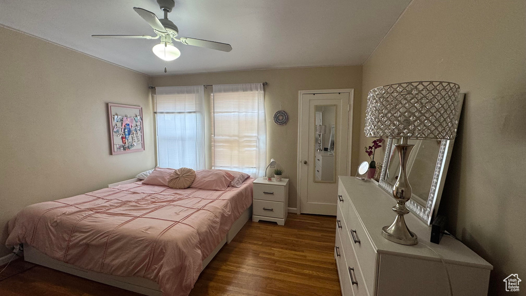 Bedroom with dark wood-style flooring and a ceiling fan