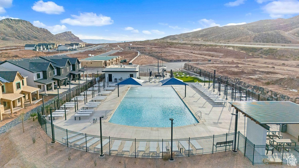 Community pool featuring a mountain view and a patio