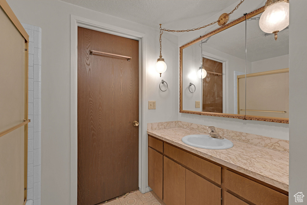 Bathroom featuring vanity and a shower
