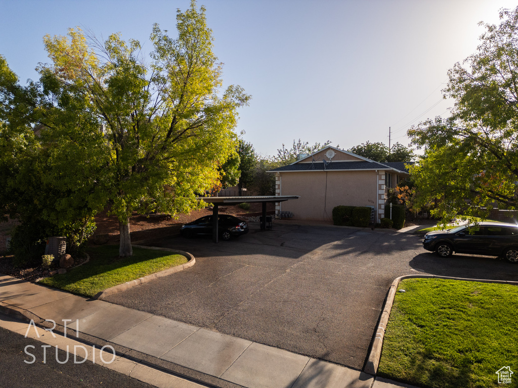 View of front of house with covered parking and stucco siding