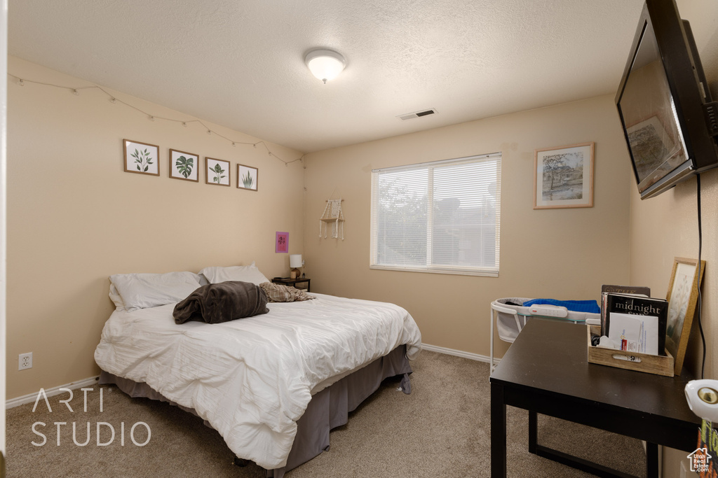 Bedroom with light carpet and baseboards