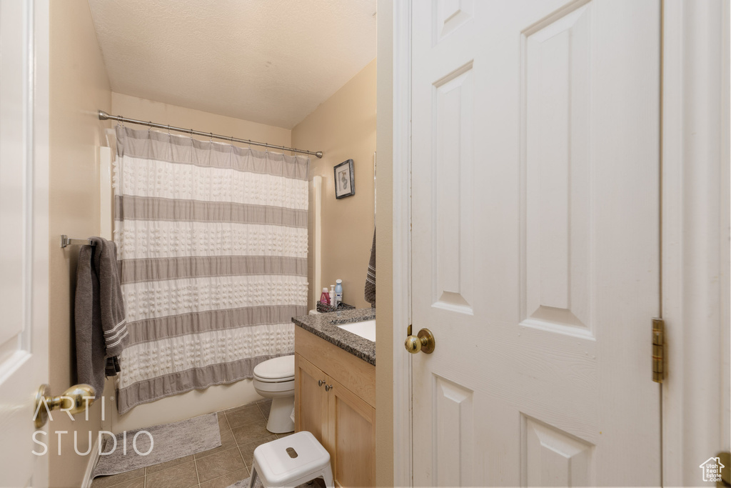 Full bath featuring vanity, tile patterned flooring, and shower / bathtub combination with curtain