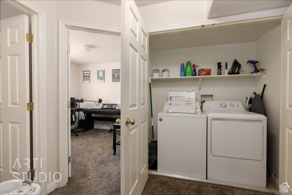 Washroom featuring independent washer and dryer and dark colored carpet