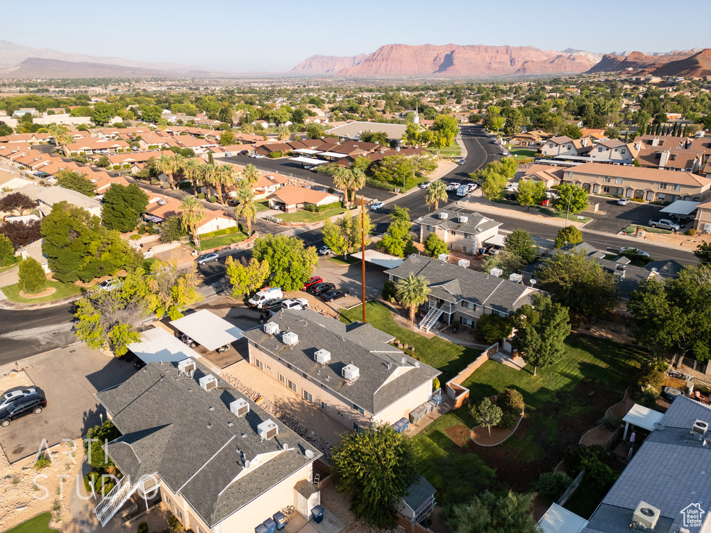Aerial overview of property's location with nearby suburban area and a mountainous background