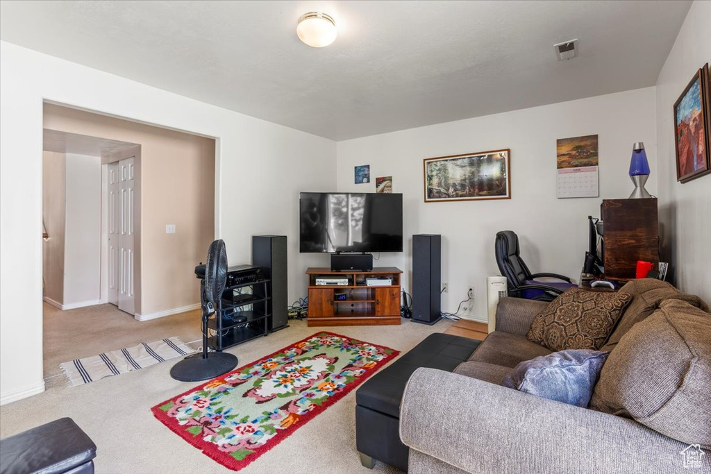 Living area with light colored carpet and baseboards