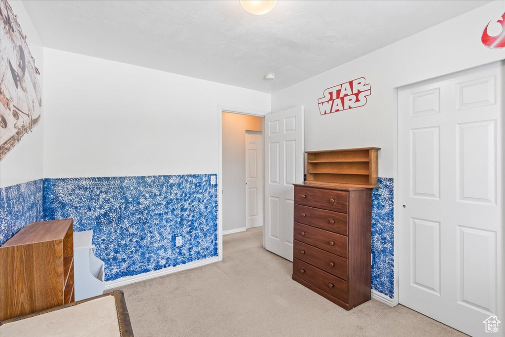 Bedroom with carpet floors and baseboards