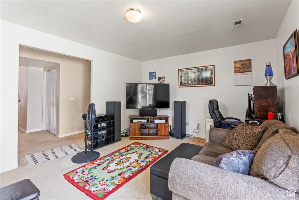 Living room with light colored carpet and baseboards