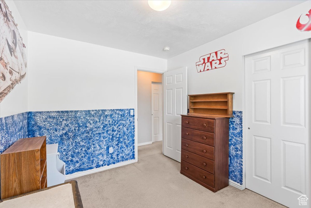 Bedroom featuring carpet flooring and baseboards