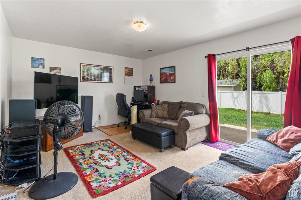 Living room featuring a desk and carpet