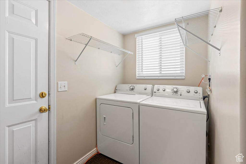 Laundry room with washing machine and dryer and baseboards