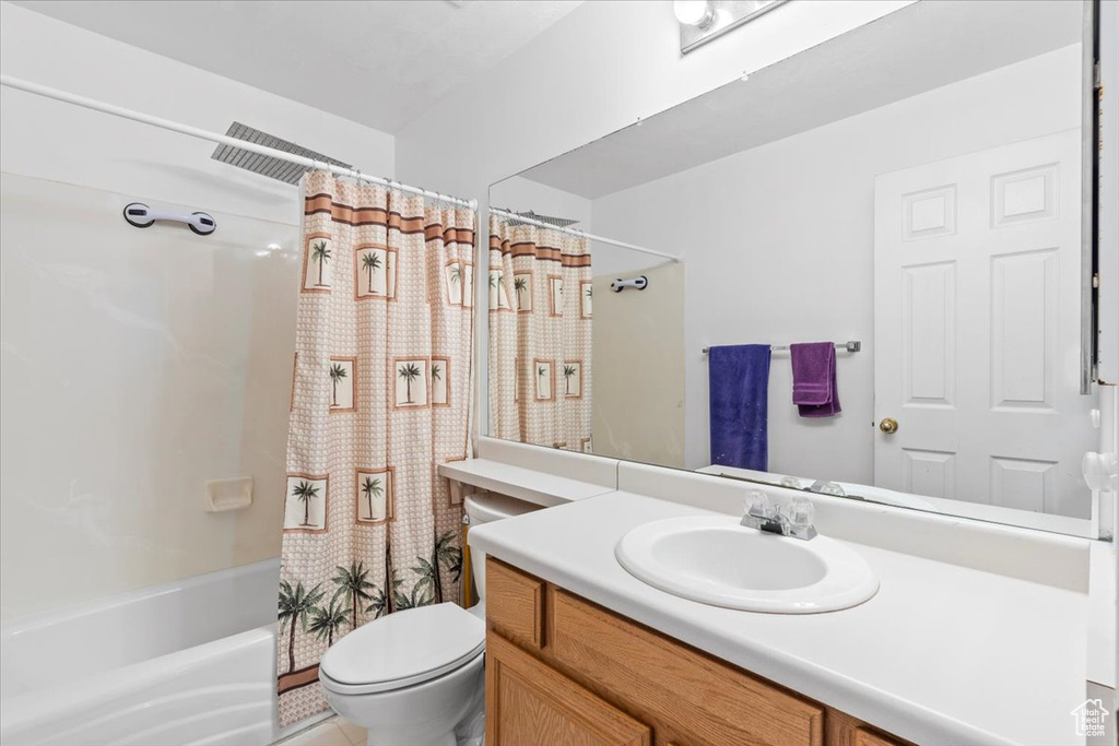 Bathroom with vanity and shower / bath combination with curtain