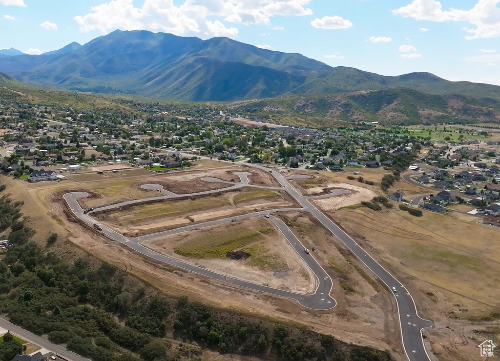 Aerial view of property's location featuring mountains and nearby suburban area