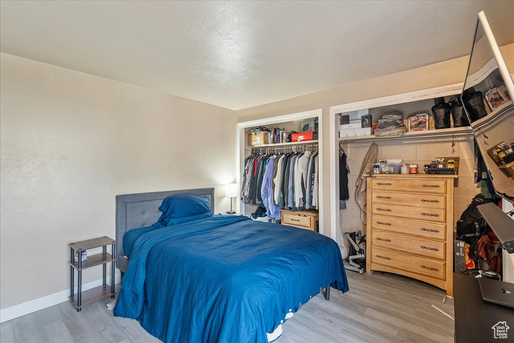 Bedroom featuring light wood-style flooring and a closet