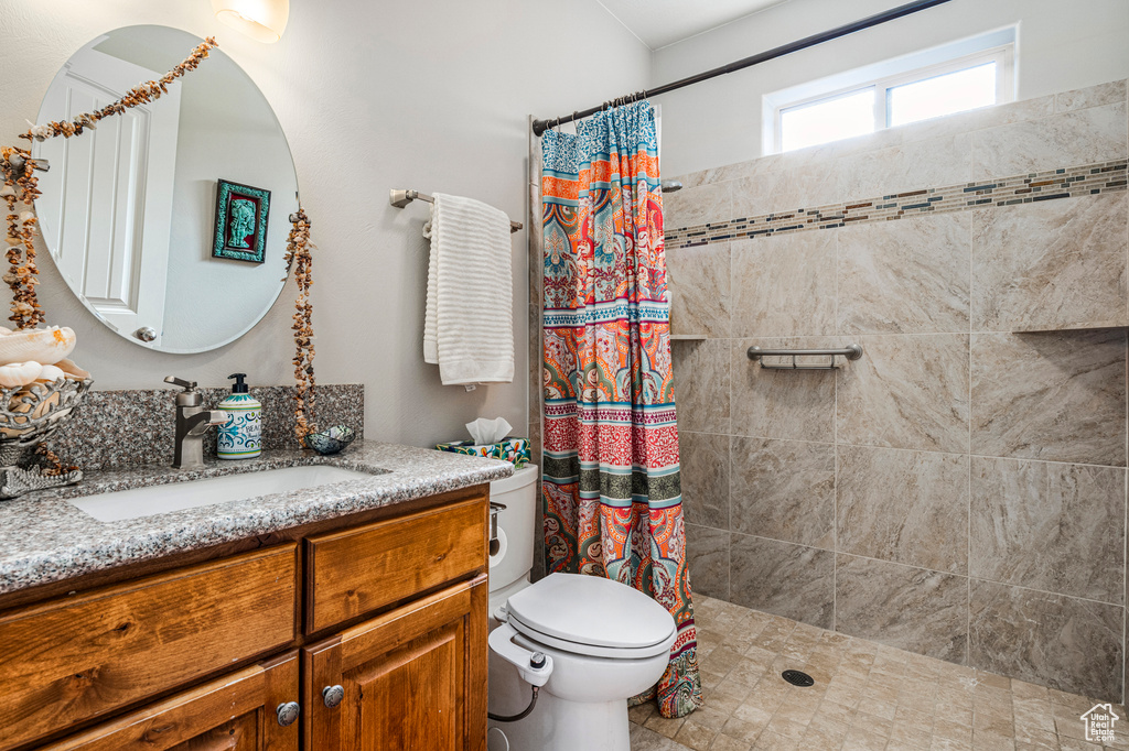 Bathroom with vanity and tiled shower