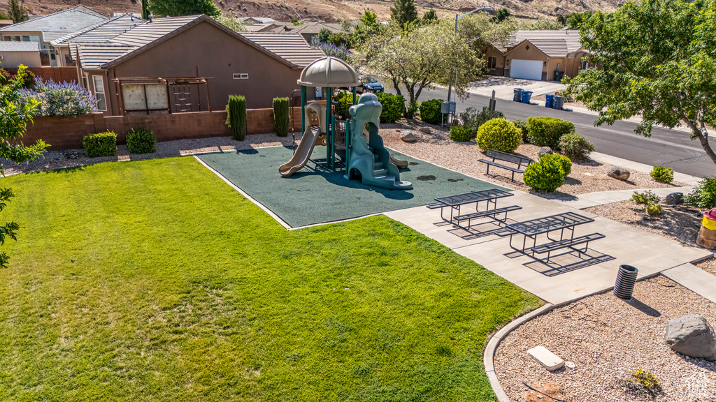 Community play area with a lawn and a mountain view