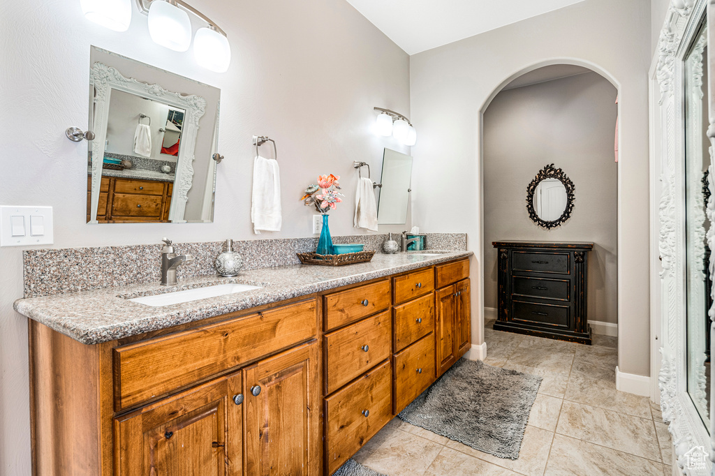 Full bathroom featuring double vanity and tile patterned floors