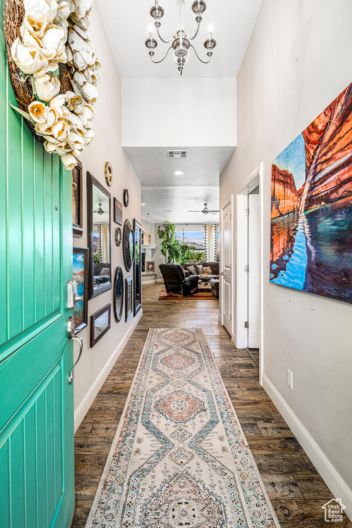 Entryway featuring a chandelier and dark wood-style floors