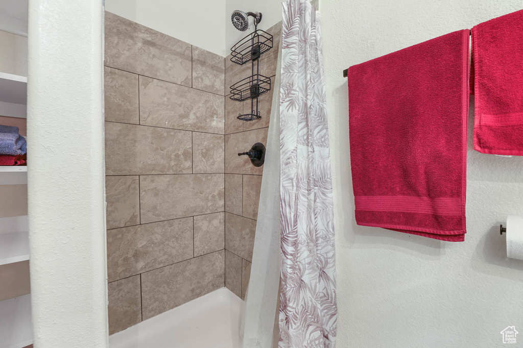 Full bathroom featuring tiled shower