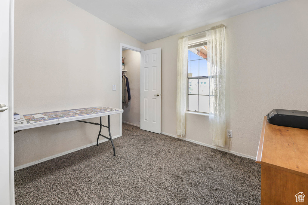 Unfurnished bedroom featuring carpet floors and baseboards
