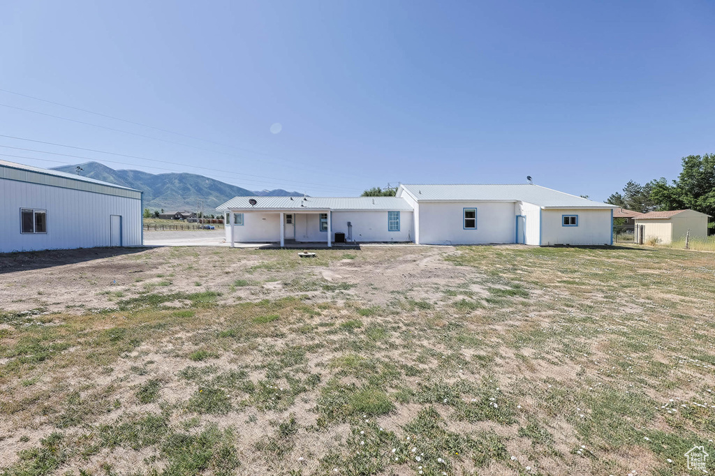 Rear view of property with a mountain view