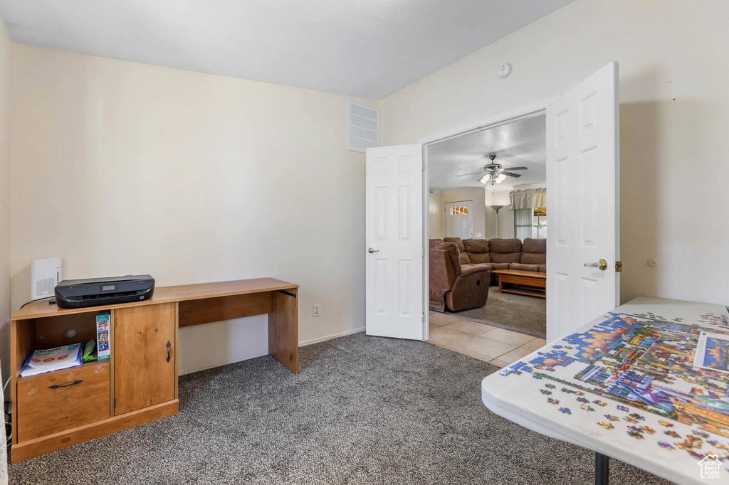 Bedroom featuring carpet and an office area