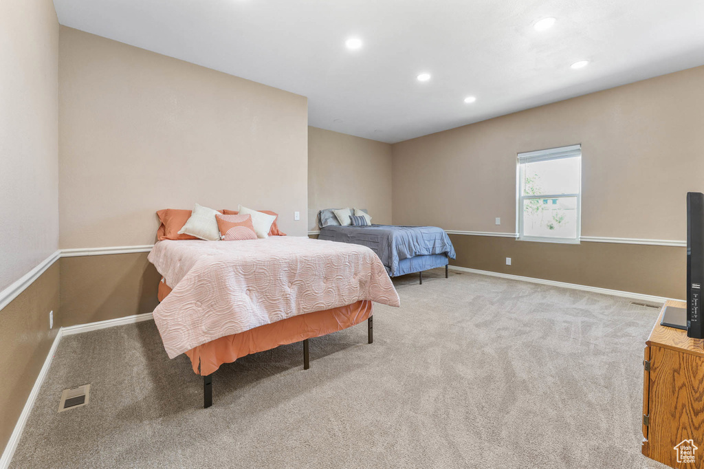 Carpeted bedroom featuring recessed lighting and baseboards