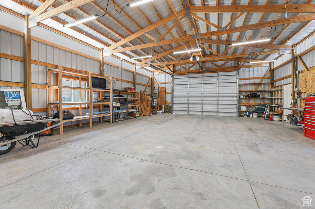 Garage featuring a workshop area and metal wall