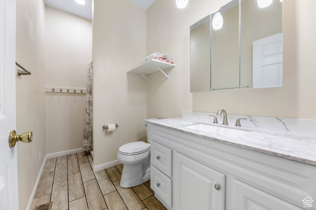 Bathroom featuring vanity and wood finish floors