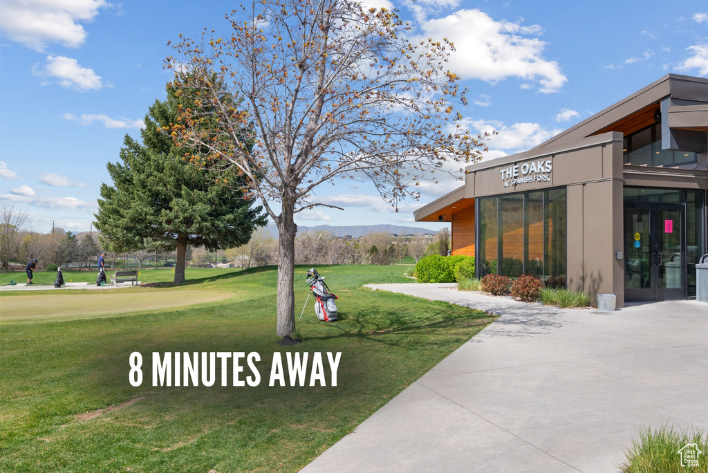Surrounding community with a lawn and a mountain view