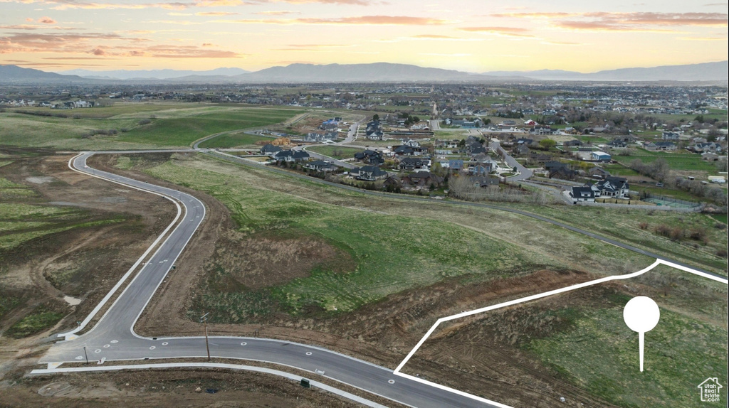 Aerial view at dusk of a mountain view and property parcel outlined
