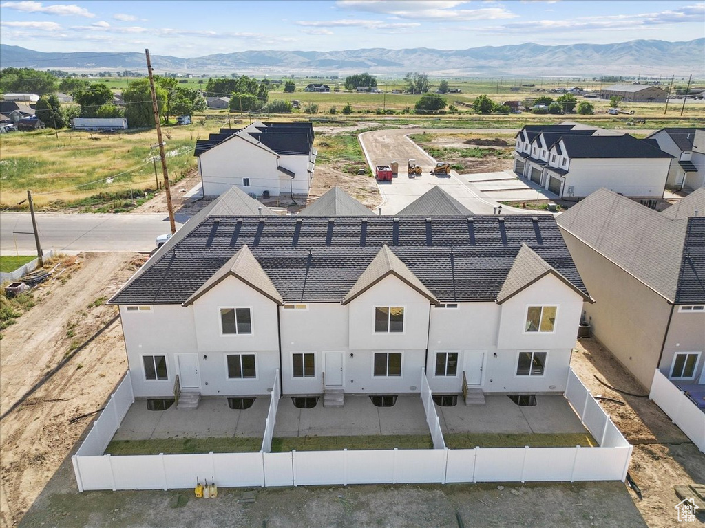 Aerial view of property and surrounding area featuring mountains