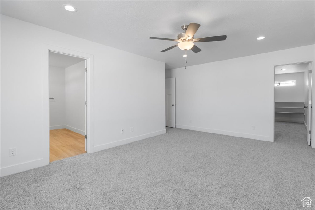 Spare room featuring carpet floors, a ceiling fan, and recessed lighting