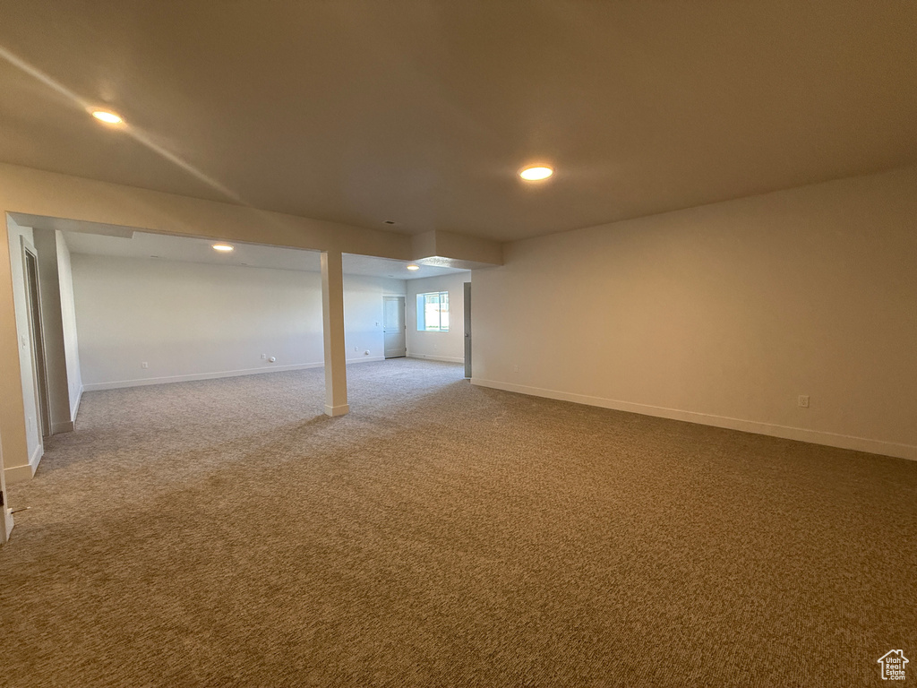 Carpeted spare room featuring baseboards and recessed lighting