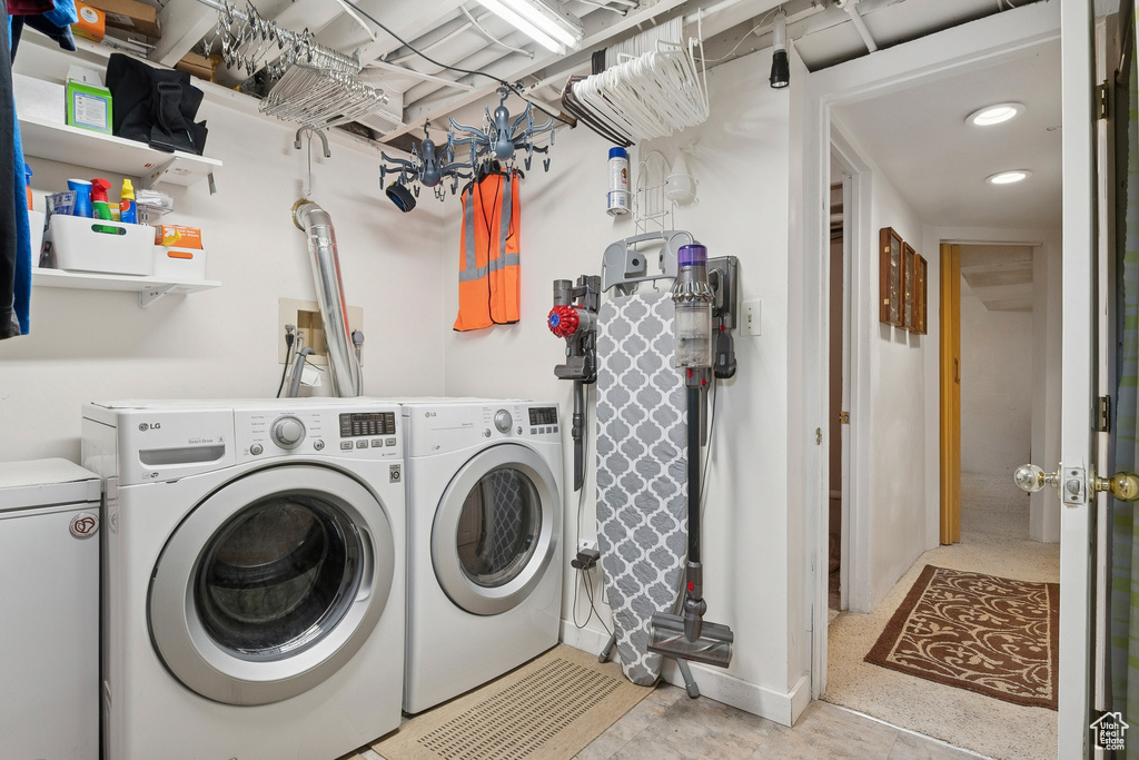 Washroom with washer and clothes dryer