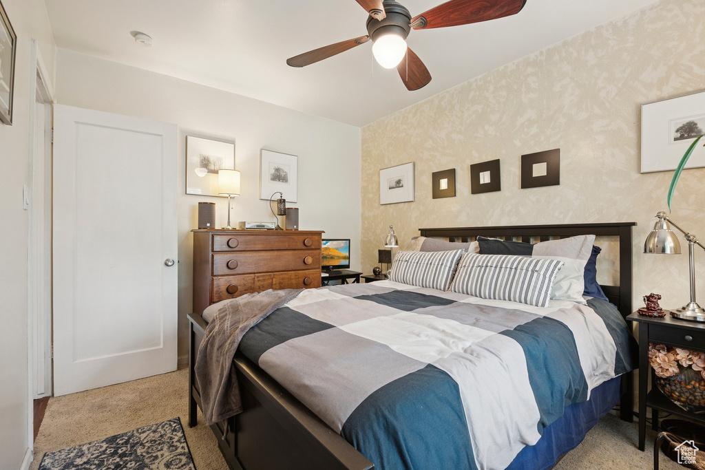 Bedroom featuring light colored carpet and a ceiling fan