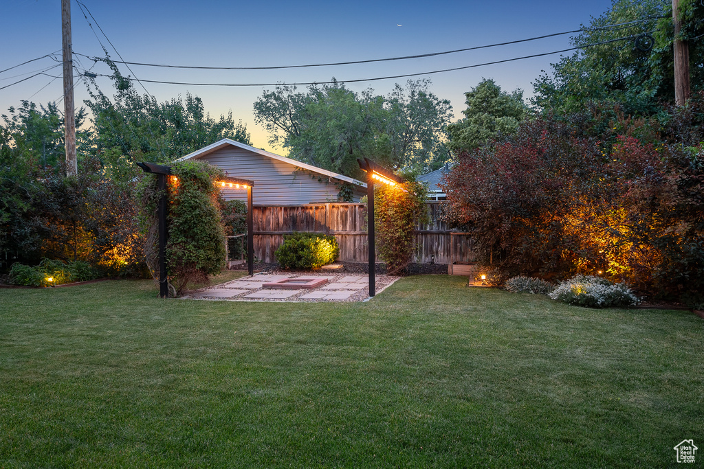 Yard at dusk with a patio area