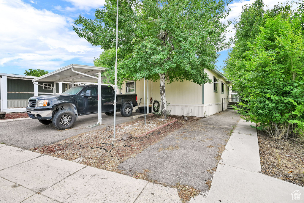 View of front facade featuring asphalt driveway