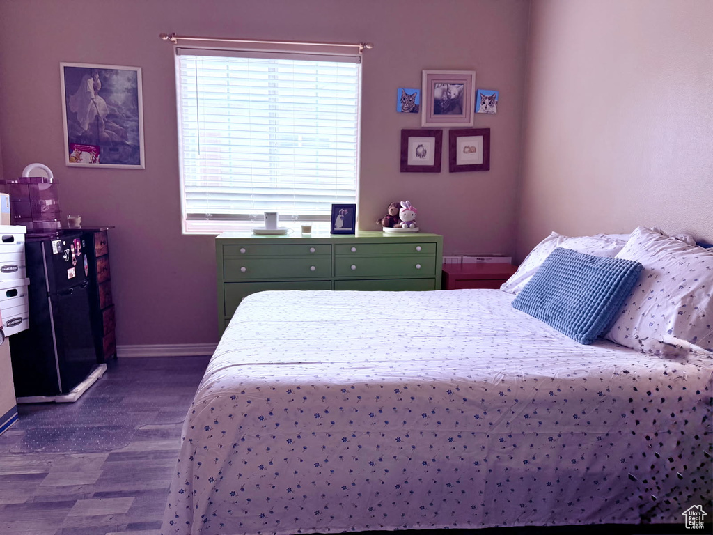 Bedroom featuring dark wood-type flooring and baseboards