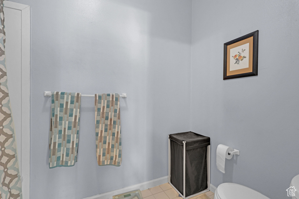 Bathroom with toilet and tile patterned floors