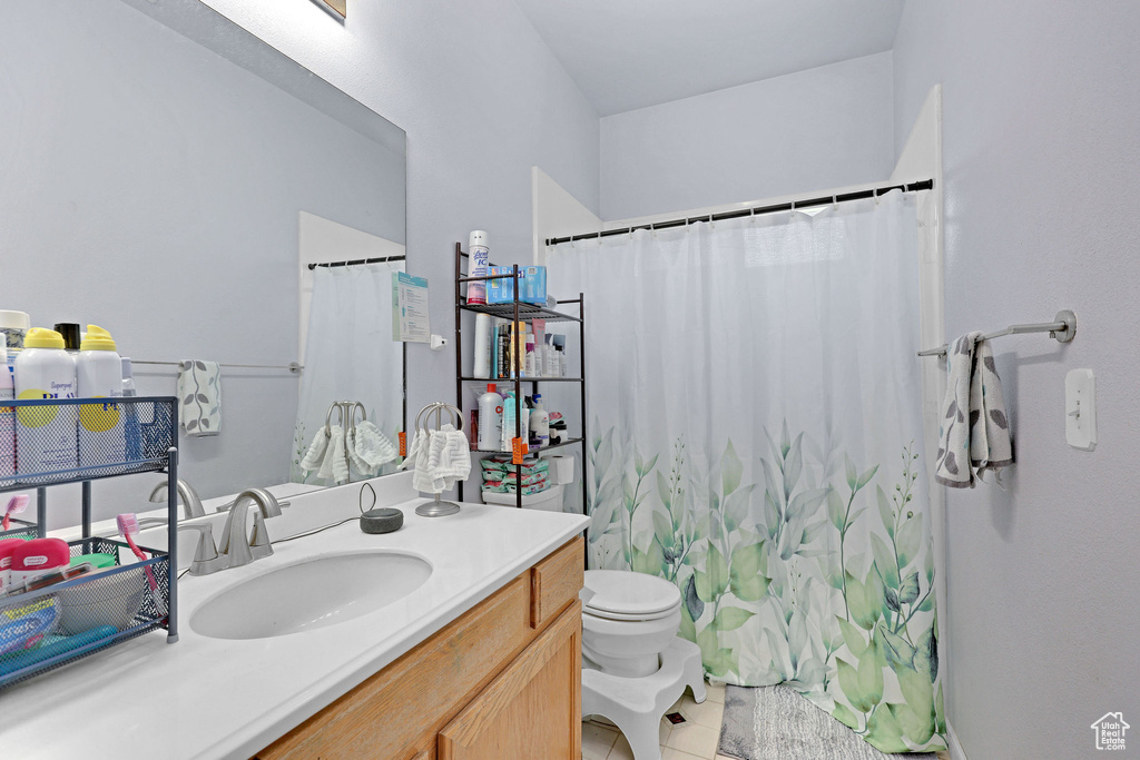 Full bathroom featuring vanity, tile patterned floors, and a shower with shower curtain