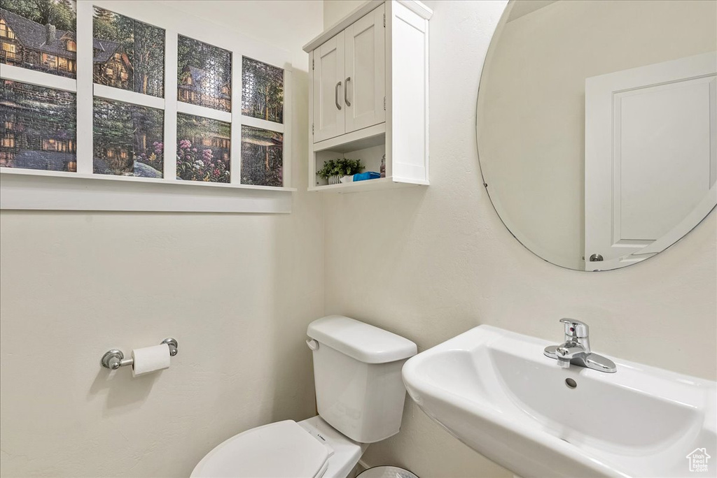 Half bathroom with a sink and toilet