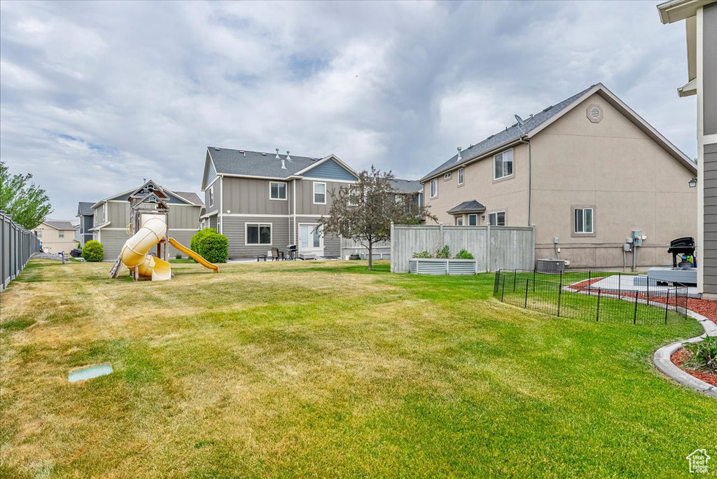View of yard featuring a playground and a residential view